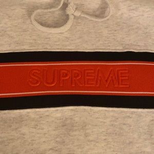 Gray supreme hoodie sweatshirt with orange and black band